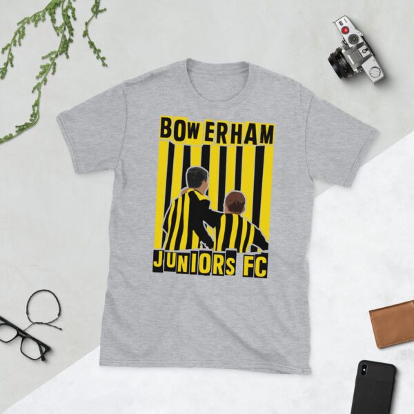 A versatile sports grey T-shirt showcasing a dynamic illustration of two boys in black and yellow stripes on the front. The back displays a small logo of a bee and castle for Bowerham Juniors FC.