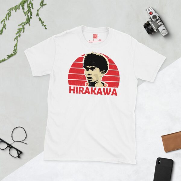 A clean white T-shirt featuring a stylised graphic of Bristol City player Yu Hirakawa's face, set against a vibrant red sunburst background. His surname "HIRAKAWA" is prominently displayed below the portrait.