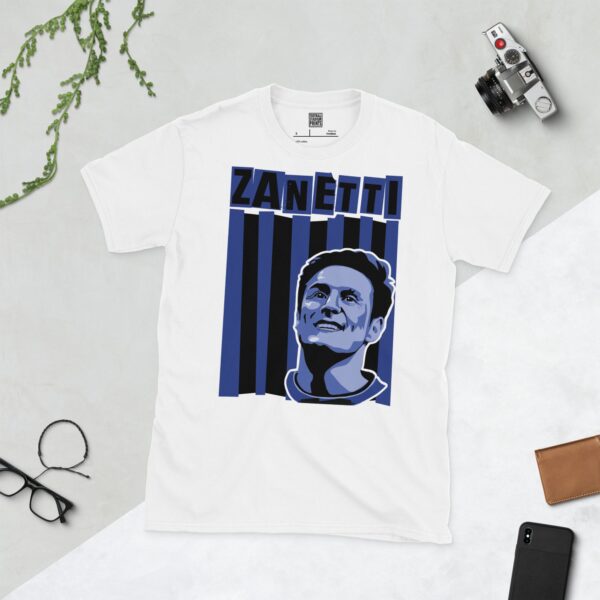 A clean white T-shirt featuring a stylized graphic of Inter Milan legend Javier Zanetti, set against a background of black and blue vertical stripes. His surname "ZANETTI" is prominently displayed above the portrait.
