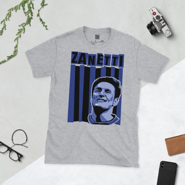 A versatile sports grey T-shirt showcasing a dynamic illustration of Javier Zanetti, the beloved Inter Milan captain. The design includes his smiling portrait over a bold black and blue striped pattern, with "ZANETTI" clearly visible above.