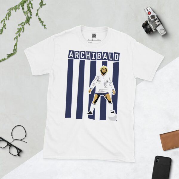 A clean white T-shirt featuring a stylized illustration of Tottenham Hotspur legend Steve Archibald in his white kit, standing against a background of bold navy and white vertical stripes, with his surname "ARCHIBALD" in block letters above.