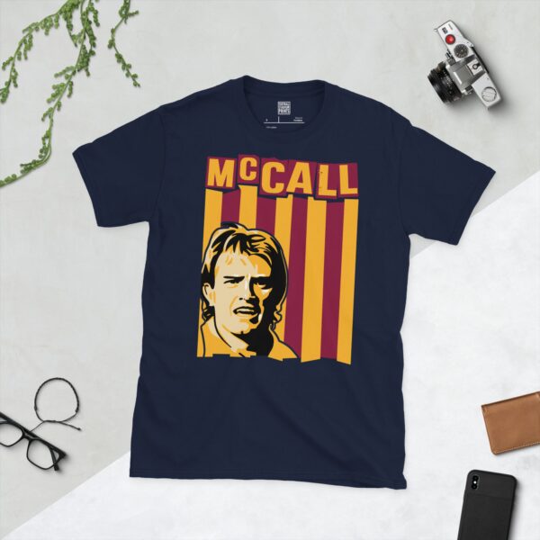 A deep navy blue T-shirt featuring a compelling graphic of Stuart McCall, the legendary Bradford City midfielder, with his image set against a vivid claret and amber striped design. His iconic surname "MCCALL" is clearly visible, paying tribute to his time at the club.