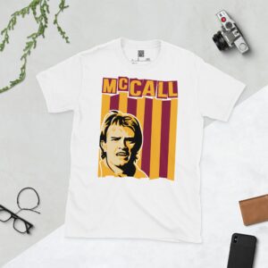 A clean white T-shirt featuring a stylized graphic of Bradford City legend Stuart McCall, set against a background of claret and amber vertical stripes. His surname "MCCALL" is prominently displayed above the portrait.