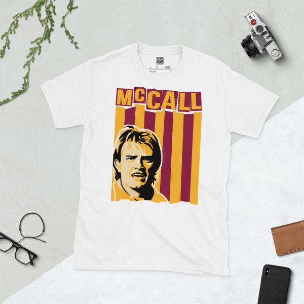 A clean white T-shirt featuring a stylized graphic of Bradford City legend Stuart McCall, set against a background of claret and amber vertical stripes. His surname "MCCALL" is prominently displayed above the portrait.