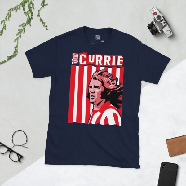 A deep navy blue T-shirt featuring a compelling graphic of Tony Currie, the legendary Sheffield United player, with his image set against a vivid red and white striped design. His name is clearly visible, paying tribute to his time at the club.