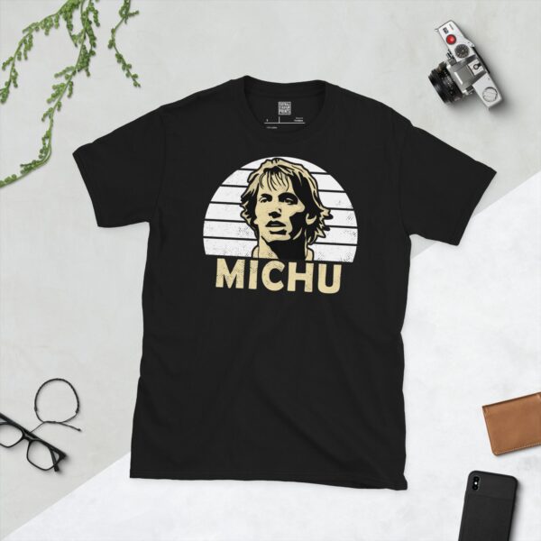 A bold black T-shirt emblazoned with a striking portrait of Swansea City icon Michu. The graphic depicts his face against a backdrop of white sunburst lines, and his surname "MICHU" is a central feature below the image.