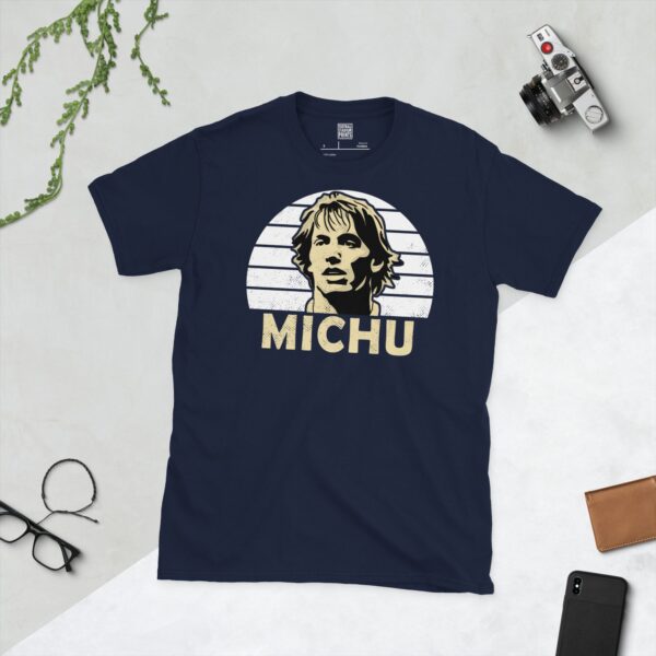 A deep navy blue T-shirt featuring a compelling graphic of Michu, the legendary Swansea City player, with his image set against a vivid white sunburst design. His iconic surname "MICHU" is clearly visible, paying tribute to his time at the club.