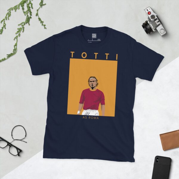 A navy T-shirt displaying a stylish illustration of Francesco Totti, the former AS Roma captain. The name "TOTTI" is above his portrait and "AS ROMA" is written beneath the image.