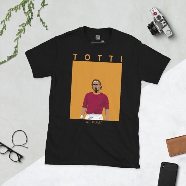 A black T-shirt featuring a clean graphic of AS Roma legend Francesco Totti in a maroon shirt. The name "TOTTI" is above the image and "AS ROMA" is below it.
