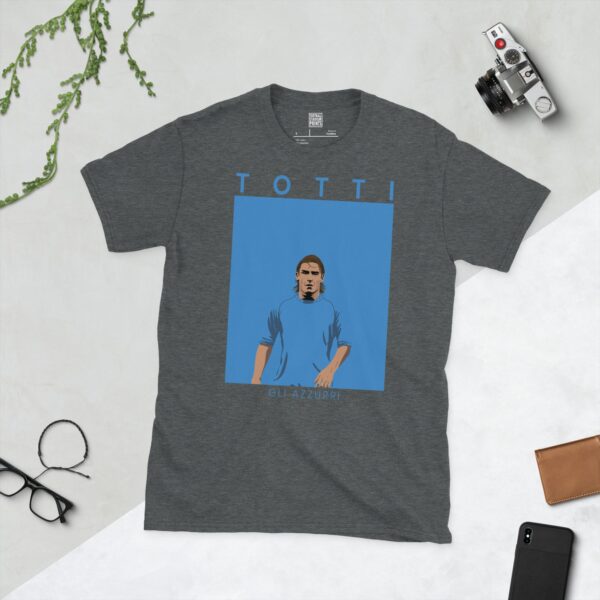 A dark heather T-shirt showing a clean, modern portrait of Francesco Totti in the blue of Italy, with "TOTTI" above and "GLI AZZURRI" below.