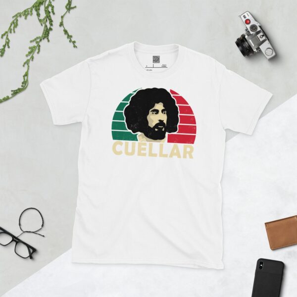 A white T-shirt with a bold portrait of football legend Leonardo Cuellar. The image is set against a green, white, and red sunburst background with the name "CUELLAR" in light yellow underneath.
