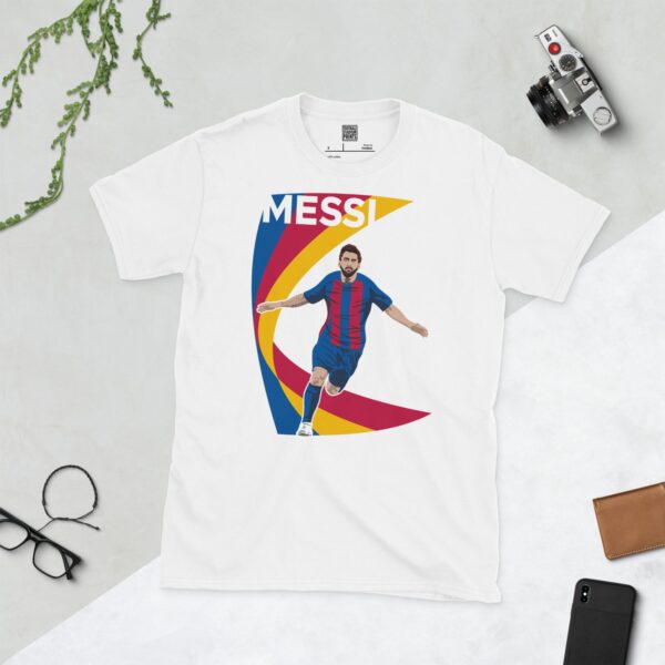 A white T-shirt with a contemporary graphic of Lionel Messi celebrating a goal. The text "MESSI" is above the image, which is backed by a dynamic red, blue, and yellow swooping design.