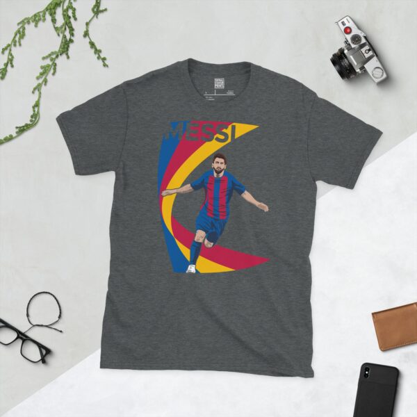 A dark heather T-shirt showing a clean, modern graphic of Lionel Messi in a red and blue kit, with the text "MESSI" above and a bold swooping design behind him.