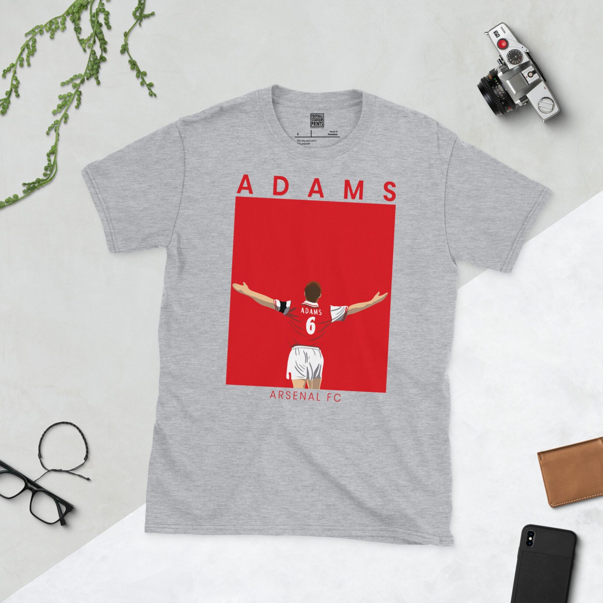 A sports grey T-shirt featuring a unique graphic of Arsenal's 'Captain Fantastic', Tony Adams, with "ADAMS" above his image and "ARSENAL FC" below.