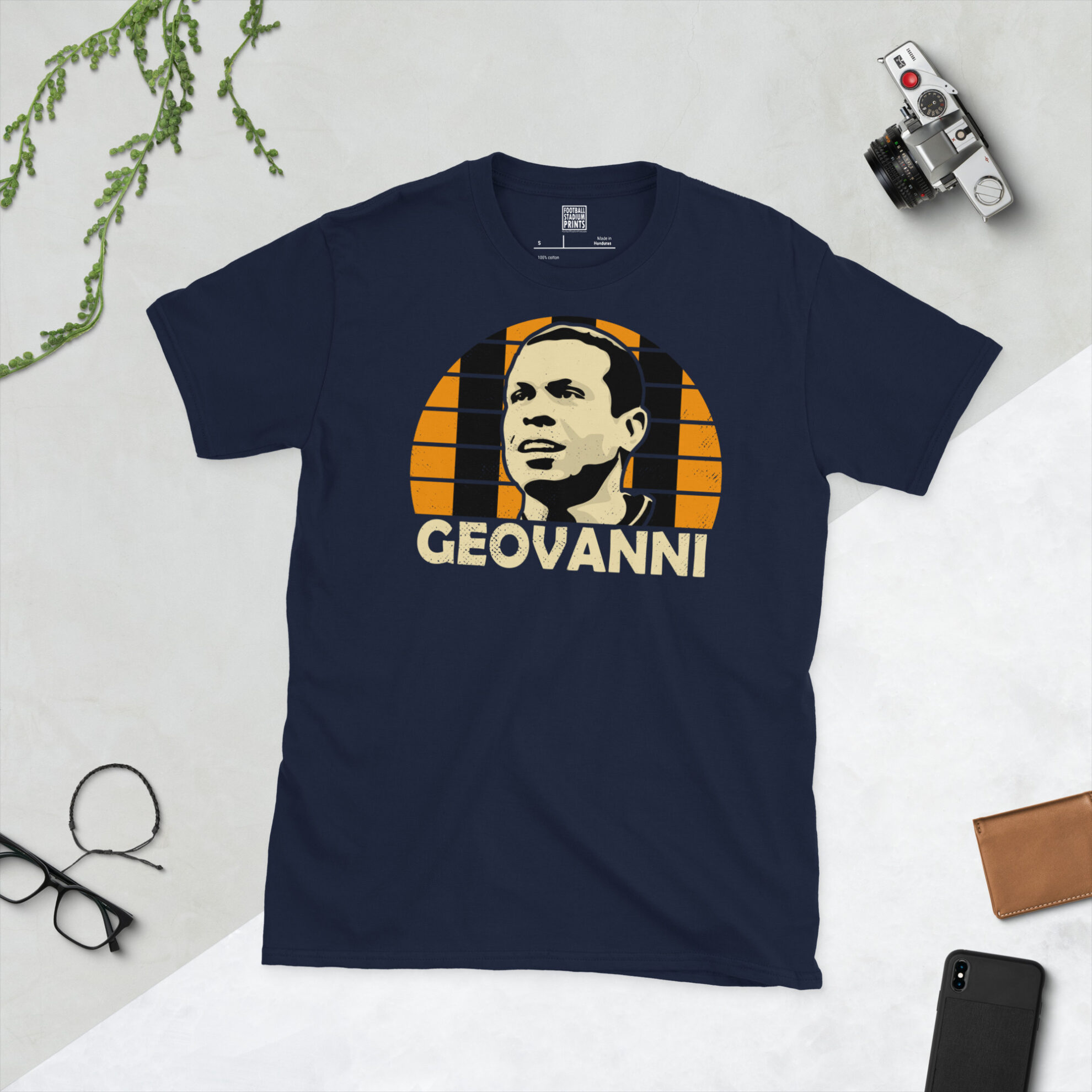 A navy T-shirt displaying an artistic illustration of Geovanni, the former Hull City midfielder. The graphic features an amber and black sunburst and the name "GEOVANNI" appears underneath in light yellow.