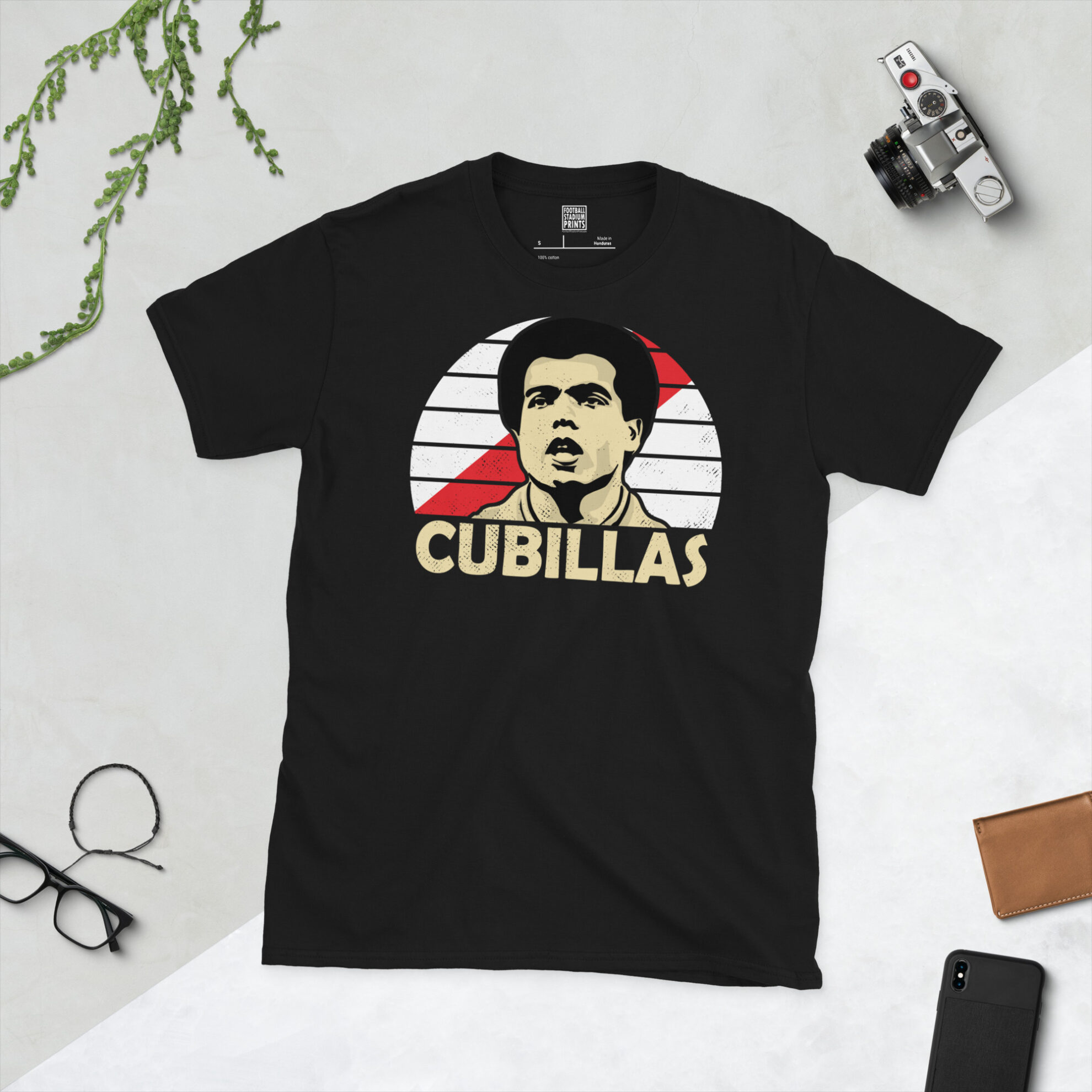 A black T-shirt featuring a stylised, distressed graphic of Peru legend Teófilo Cubillas. The portrait is backed by a white sunburst with a red sash, with the name "CUBILLAS" printed in light yellow below.