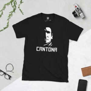 A black T-shirt featuring a stylised graphic of Manchester United legend Eric Cantona with the name "CANTONA" printed in white below.