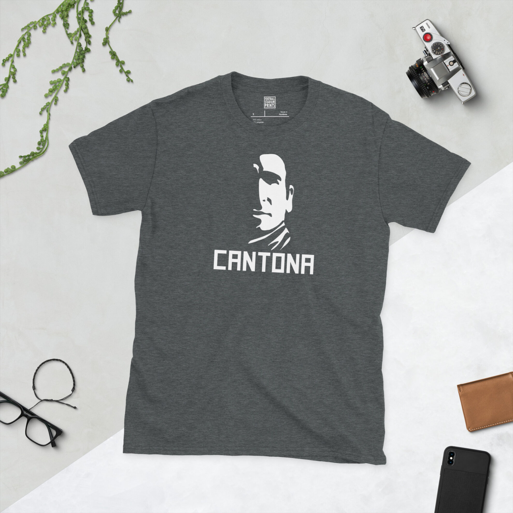 A dark heather grey t-shirt featuring a white silhouette-style illustration of Eric Cantona, a unique fan-inspired design.