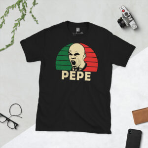 A black T-shirt featuring a stylised, distressed graphic of Portugal legend Pepe. The portrait is backed by a green and red sunburst inspired by the national flag, with the name "PEPE" printed below.
