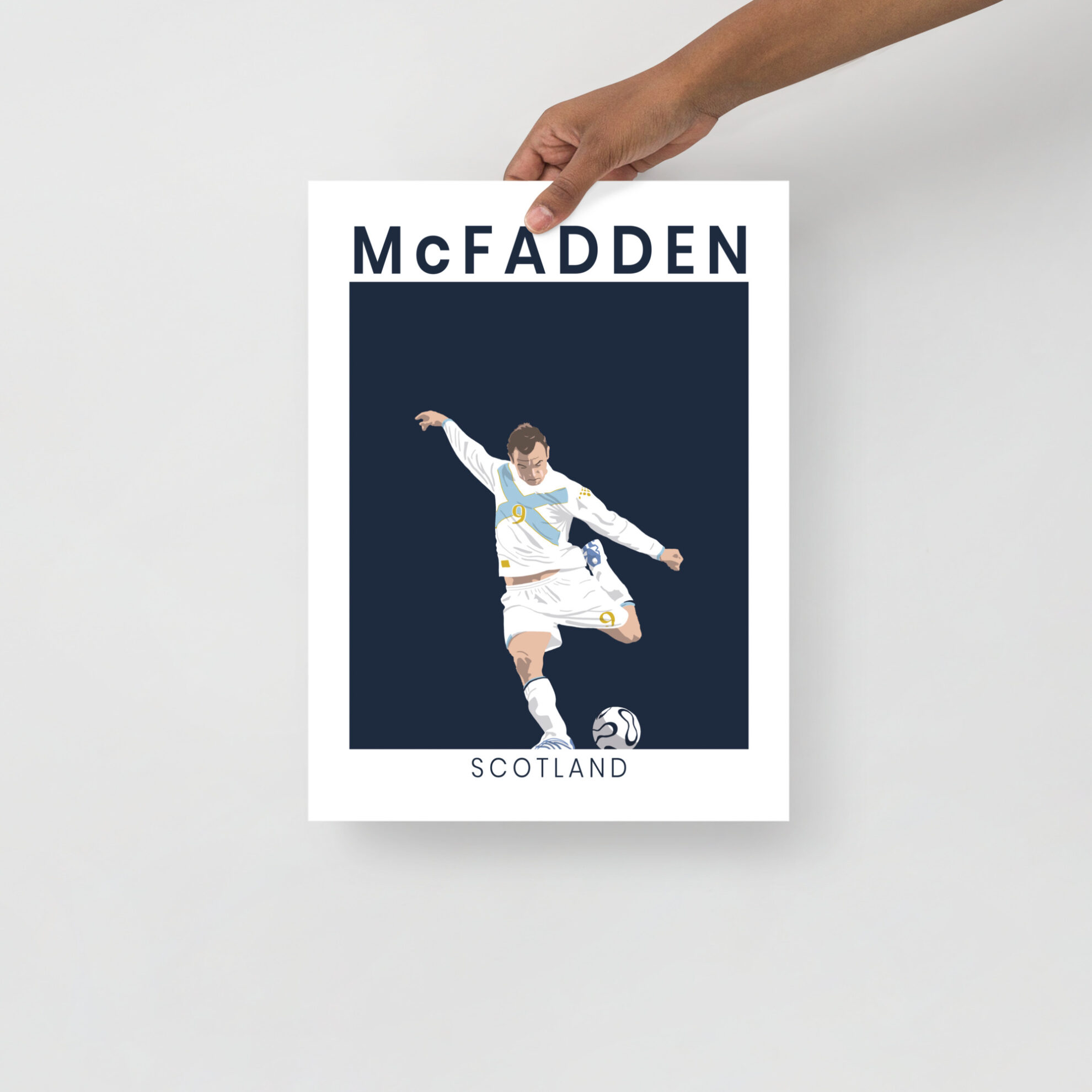 A minimalist art print of James McFadden striking the ball in his white and saltire-blue Scotland away kit against France in Paris.