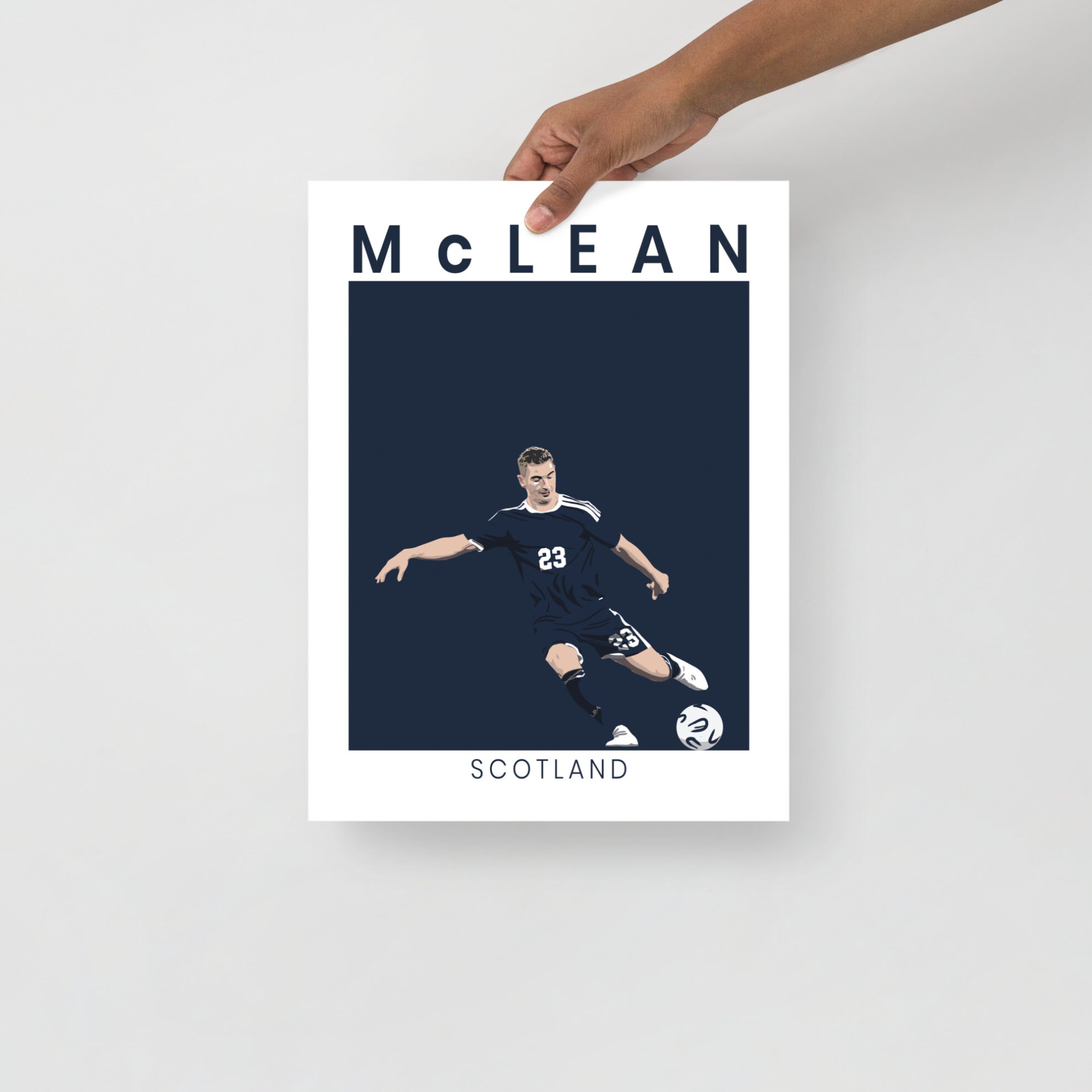 A stylised art print of Kenny McLean in a goal-scoring pose for Scotland against Denmark, featuring a minimalist navy and white design.