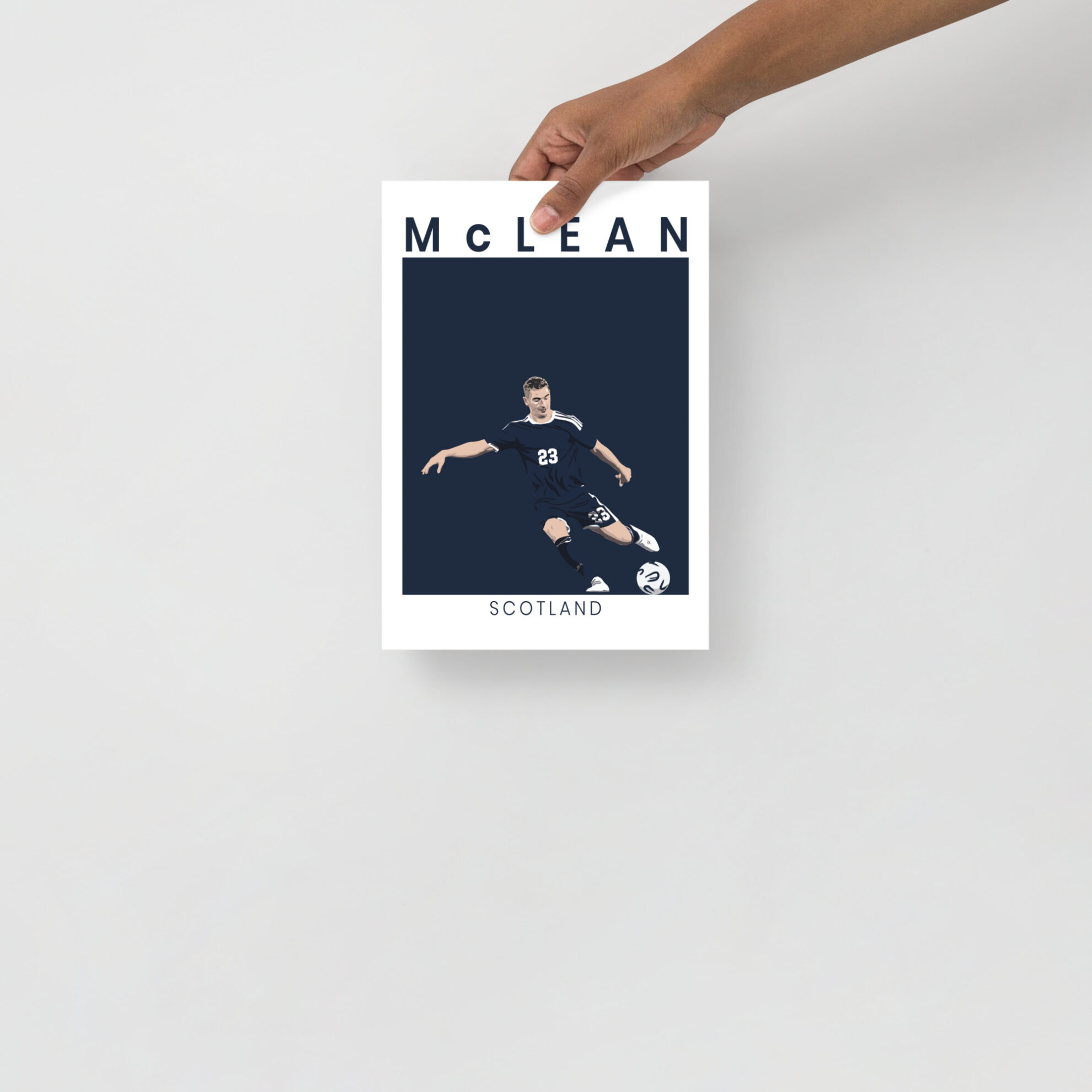 A stylised art print of Kenny McLean in a goal-scoring pose for Scotland against Denmark, featuring a minimalist navy and white design.