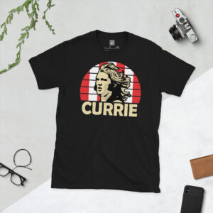 A black T-shirt featuring a stylised graphic of Sheffield United legend Tony Currie. The portrait is backed by a red and white striped sunburst with the name "CURRIE" below.