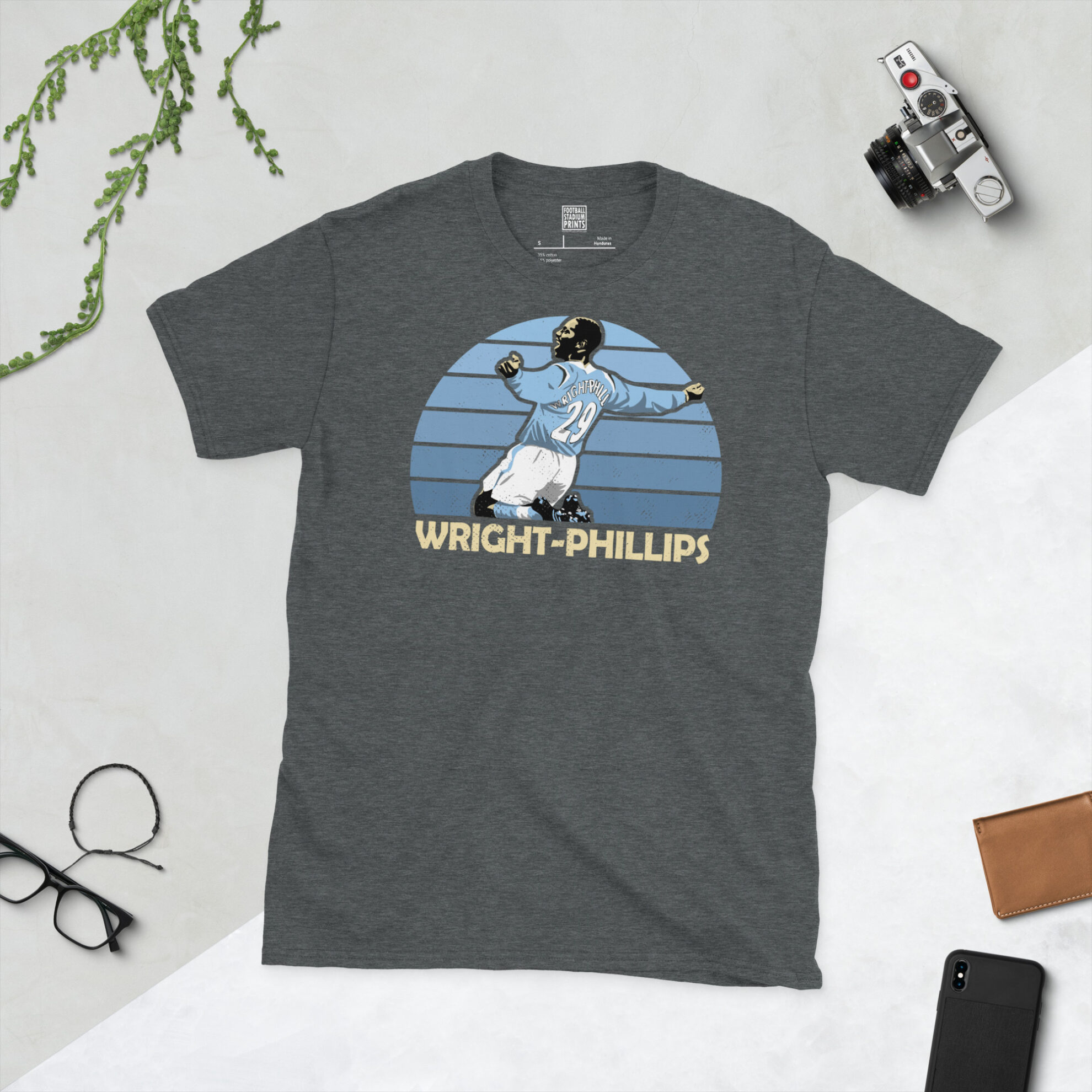 A dark heather grey T-shirt with a vintage-style graphic of fan favourite Shaun Wright-Phillips, celebrating his iconic spells at Manchester City.