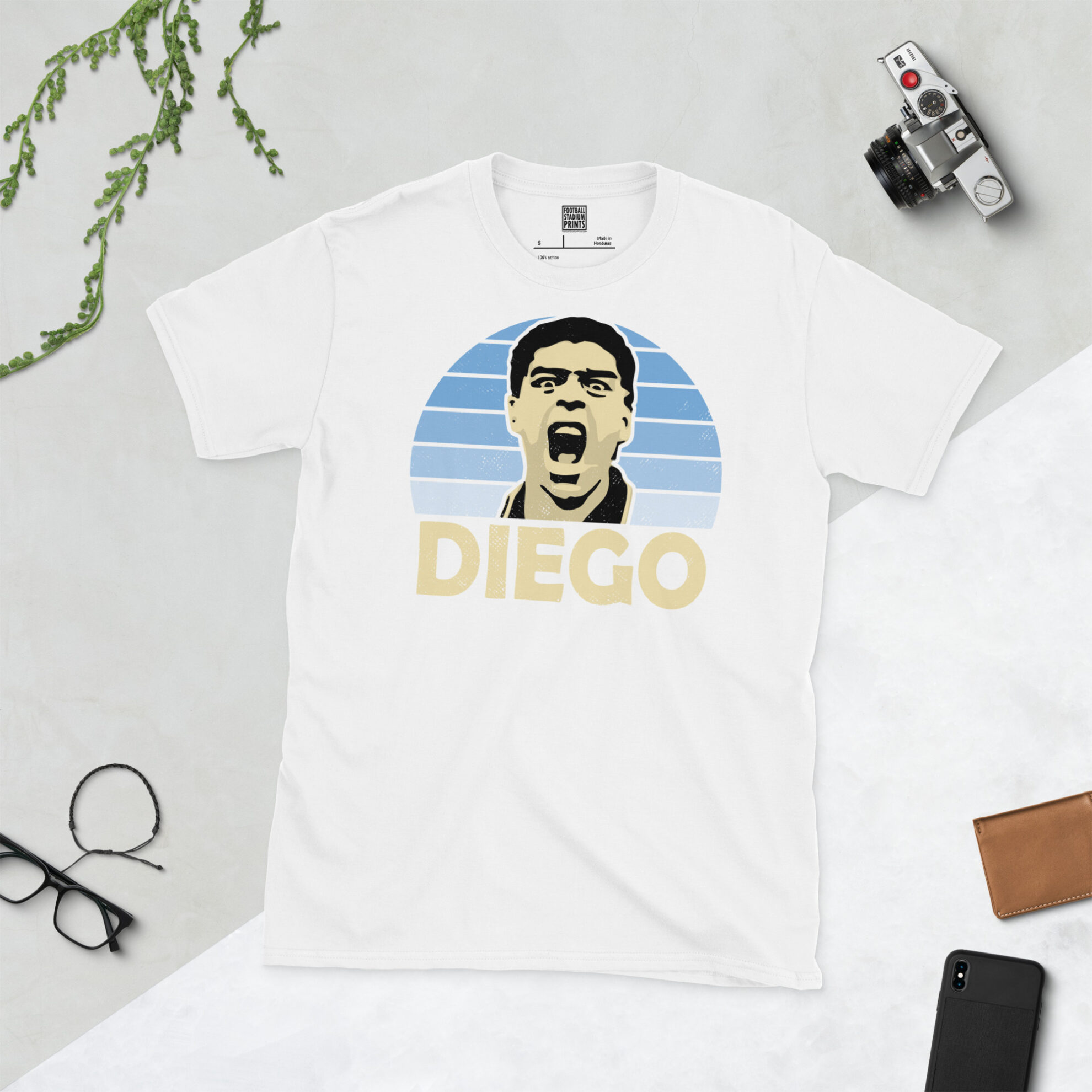 A clean white T-shirt featuring a high-definition distressed print of Diego Maradona during his final World Cup campaign with Argentina.