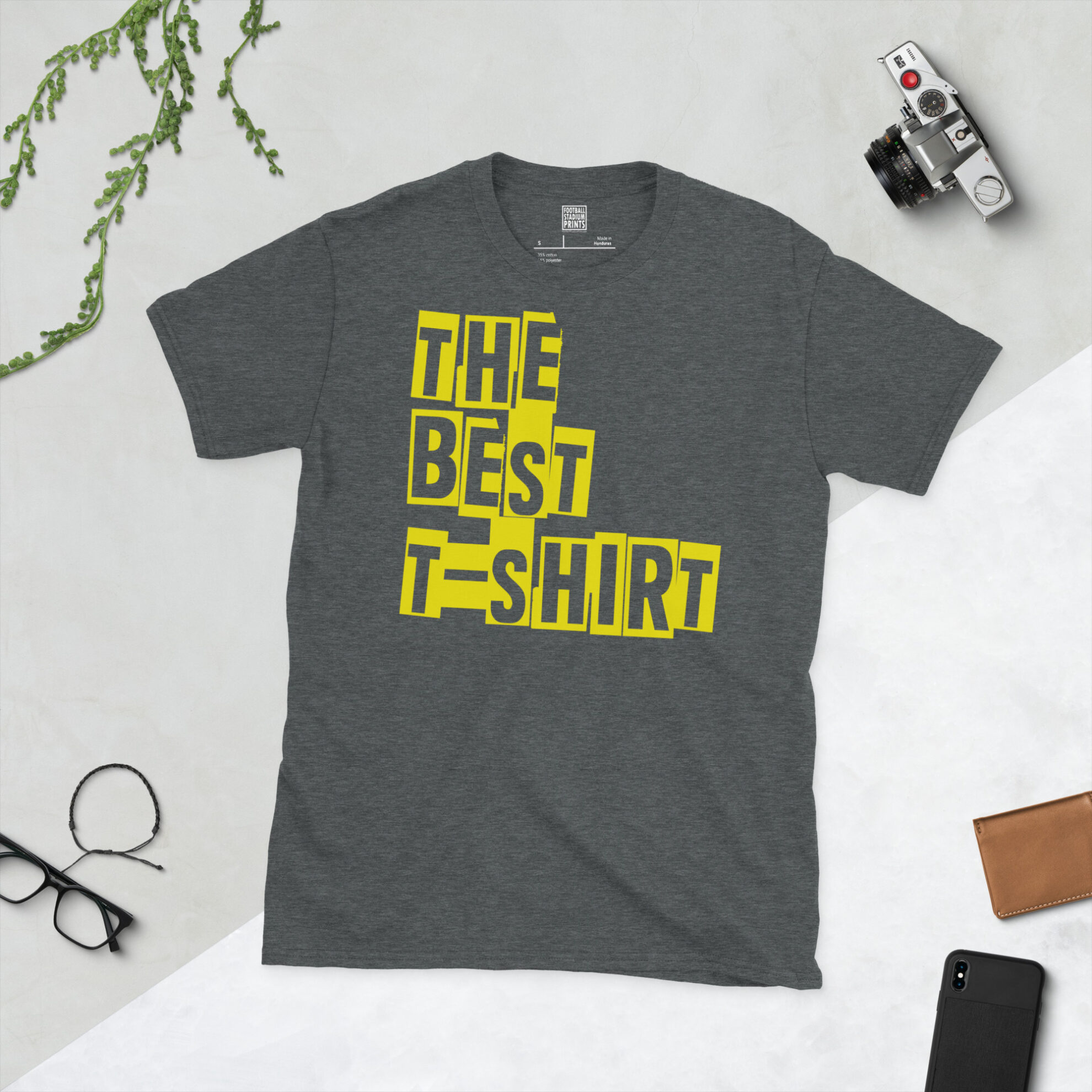Front view of a dark heather crew neck graphic tee printed with 'The Best T-Shirt' in bold typography.