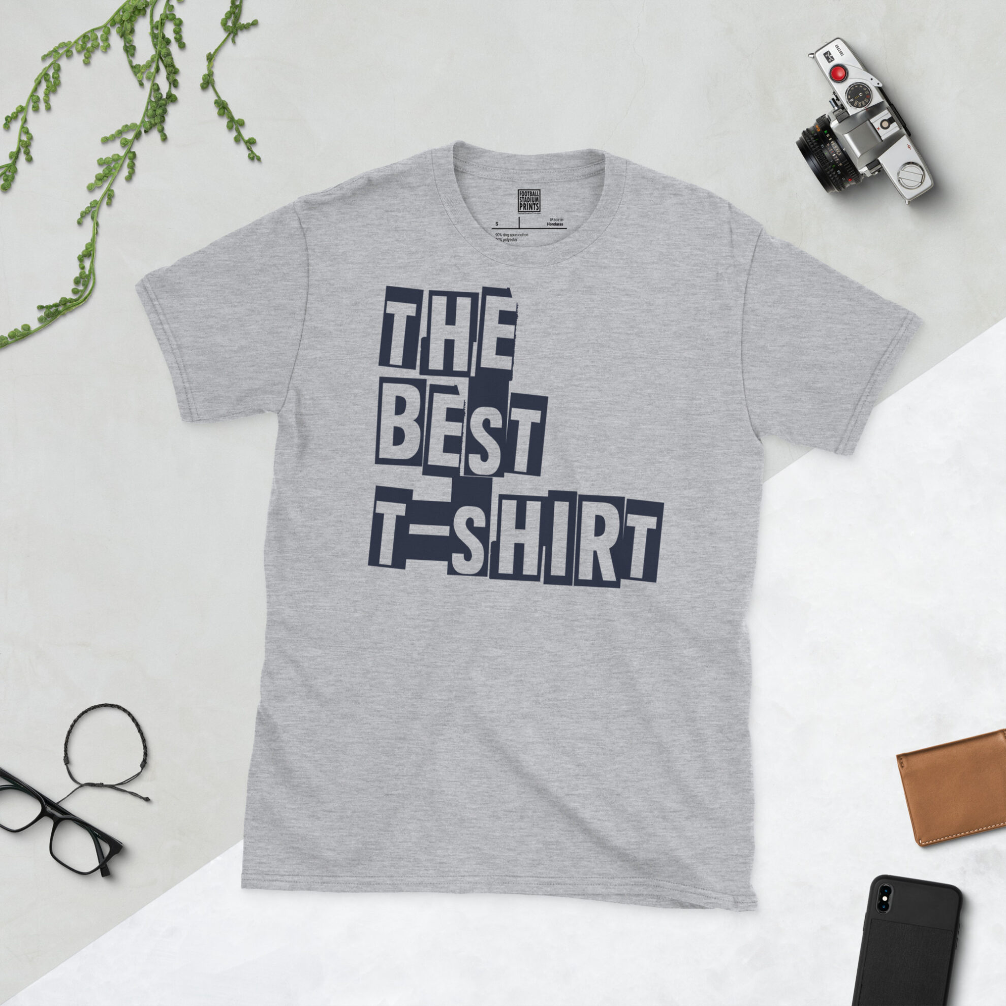 Front view of a sports grey crew neck graphic tee printed with 'The Best T-Shirt' in bold typography.