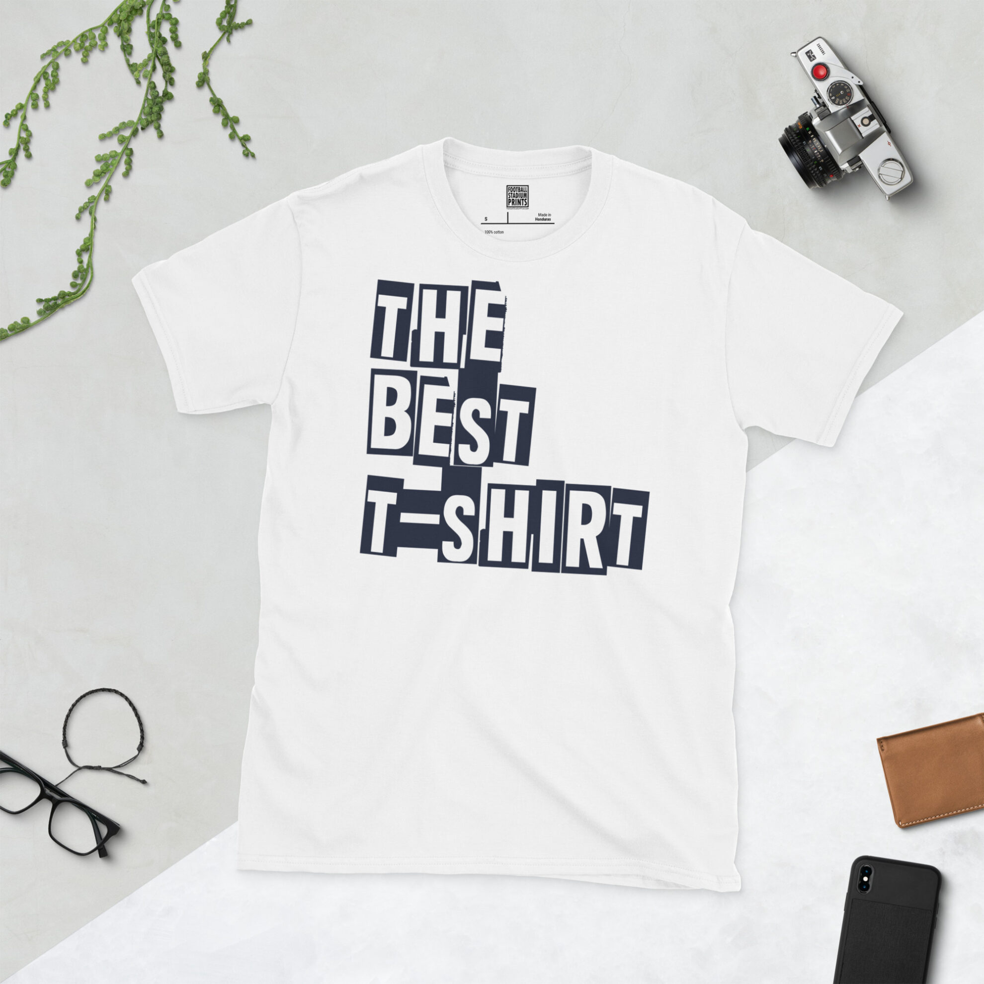 Front view of a white crew neck graphic tee printed with 'The Best T-Shirt' in bold typography.