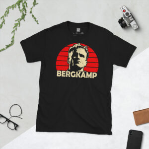 A premium black T-shirt featuring a distressed red sunburst graphic of Arsenal legend Dennis Bergkamp with "BERGKAMP" in bold lettering.