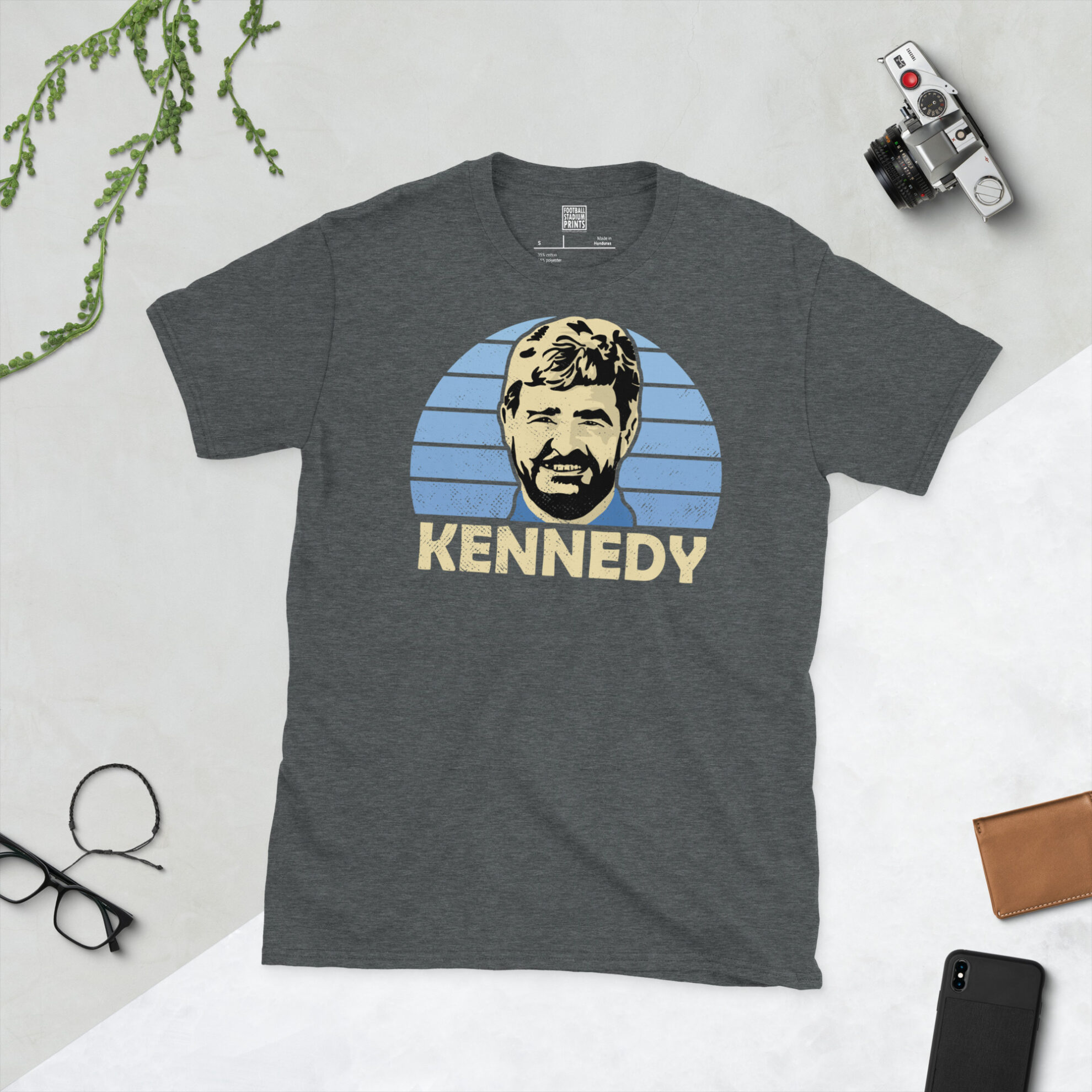 A dark heather grey T-shirt with a vintage-style graphic of Stewart Kennedy, celebrating his legendary career with the Loons.