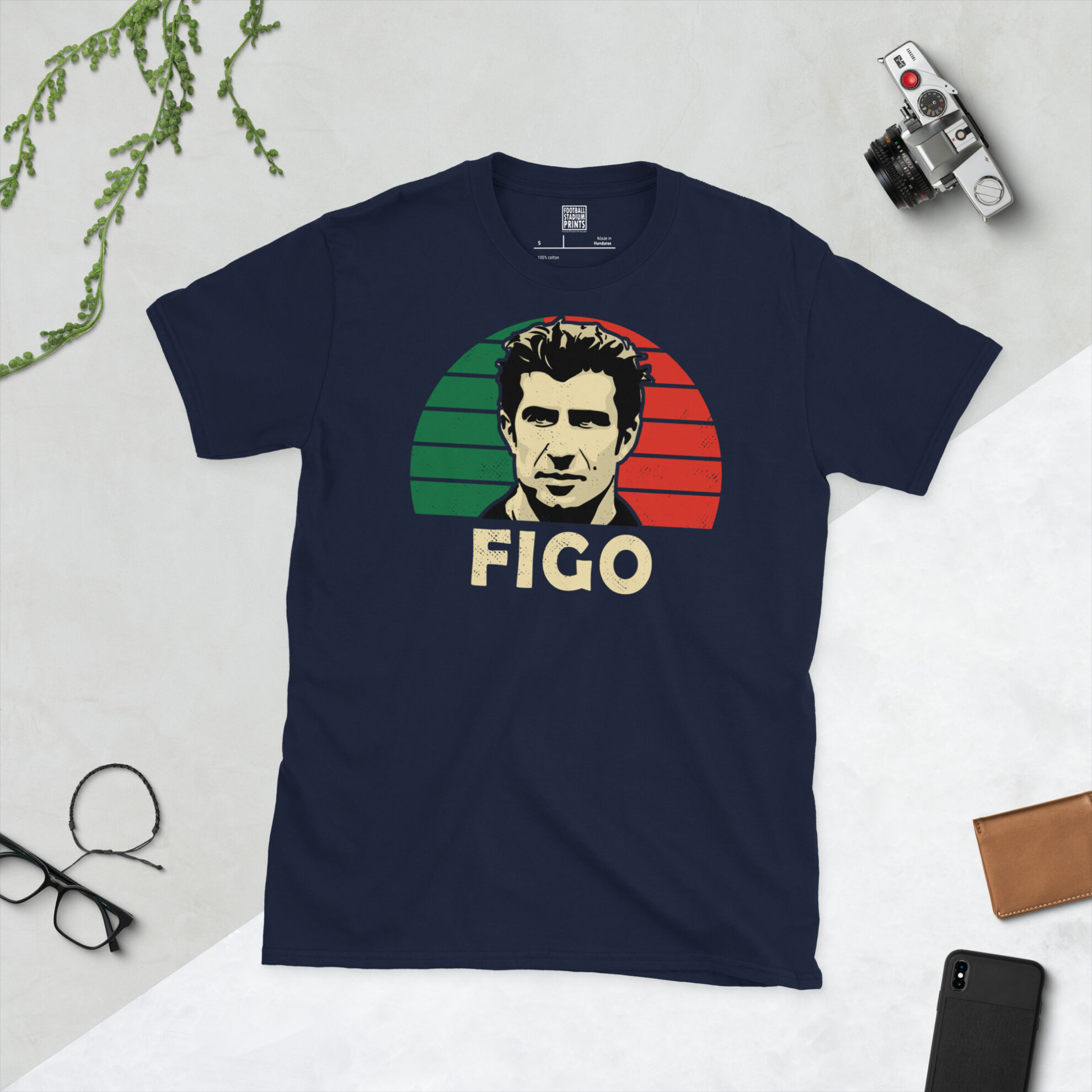A navy blue T-shirt showcasing a high-contrast illustration of Portuguese icon Luís Figo against a green and red sunburst backdrop.