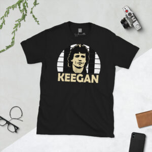 A premium black T-shirt featuring a distressed black and white striped graphic of Newcastle United legend Kevin Keegan with "KEEGAN" in bold lettering.